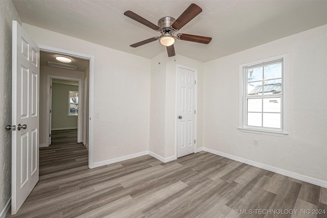 empty room featuring ceiling fan and hardwood / wood-style flooring