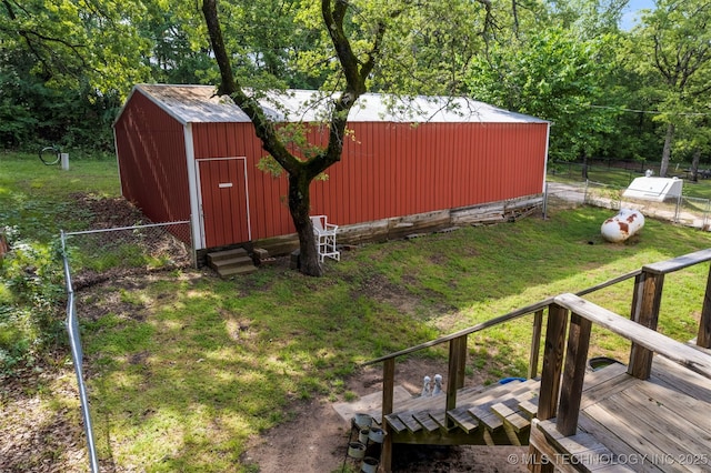 view of yard with a wooden deck and a storage shed