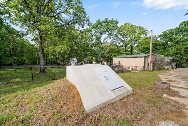 view of storm shelter featuring a storage unit and a lawn