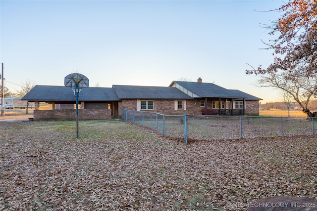 view of back house at dusk