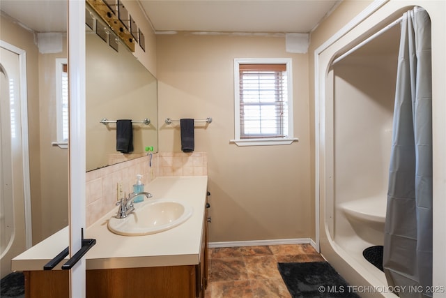 bathroom featuring vanity and tasteful backsplash