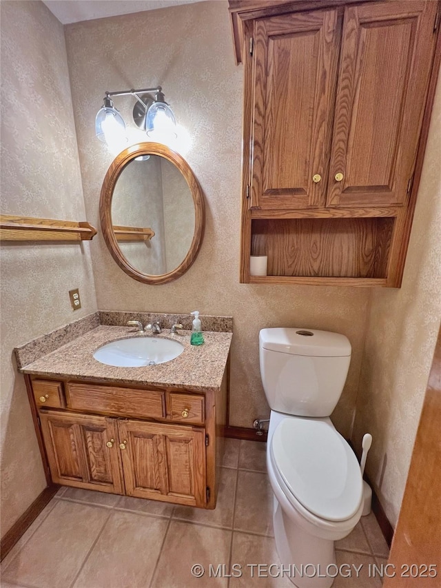 bathroom with tile patterned floors, vanity, and toilet