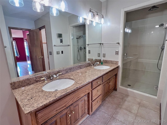 bathroom featuring tile patterned floors, vanity, and a shower with shower door