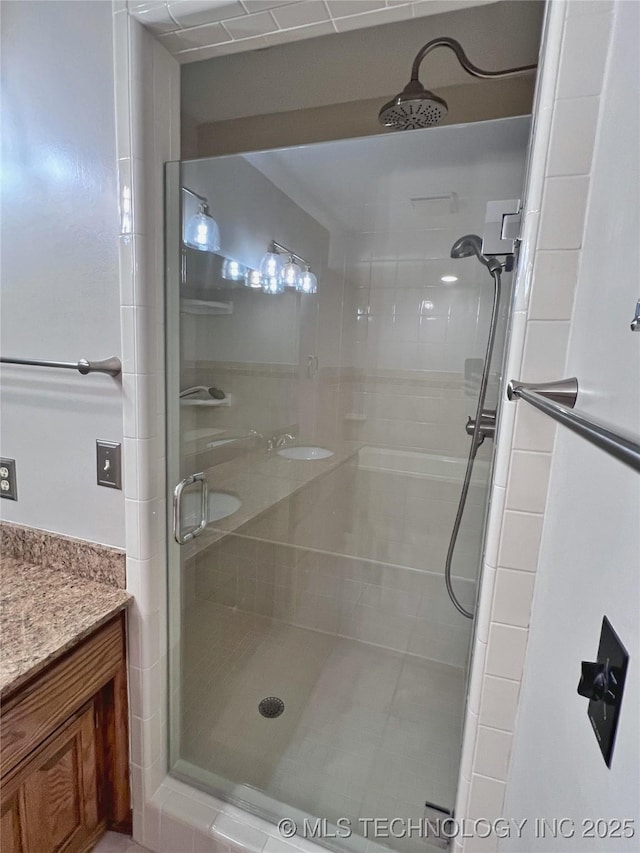 bathroom with vanity and a shower with shower door