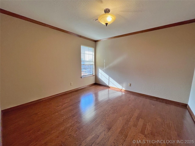 unfurnished room with hardwood / wood-style floors, a textured ceiling, and ornamental molding