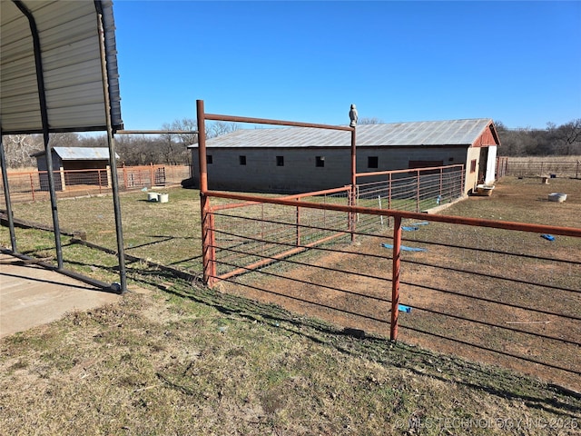 view of yard with a rural view and an outbuilding