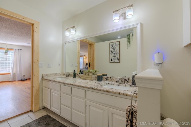 bathroom featuring vanity, a textured ceiling, and tile patterned floors