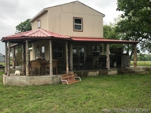 back of property featuring a lawn