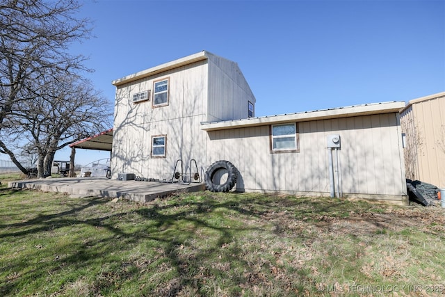 rear view of property featuring a yard