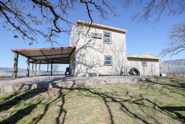 rear view of property featuring a lawn