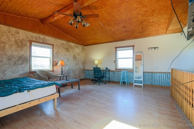 bedroom with wood ceiling, hardwood / wood-style flooring, multiple windows, and lofted ceiling with beams