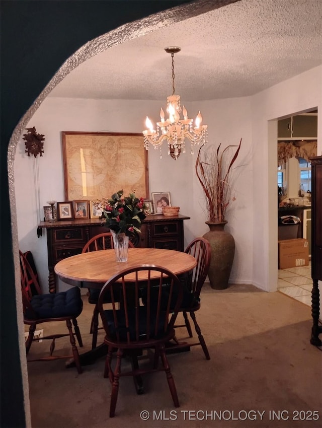 dining room featuring a notable chandelier and a textured ceiling