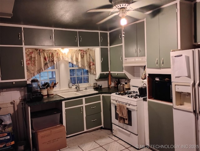 kitchen featuring light tile patterned floors, white appliances, and sink