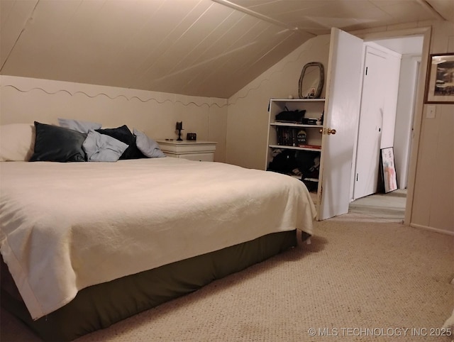 bedroom featuring light carpet and vaulted ceiling