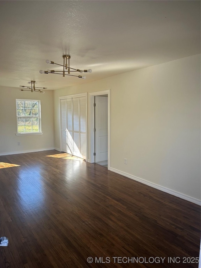 empty room featuring dark hardwood / wood-style flooring