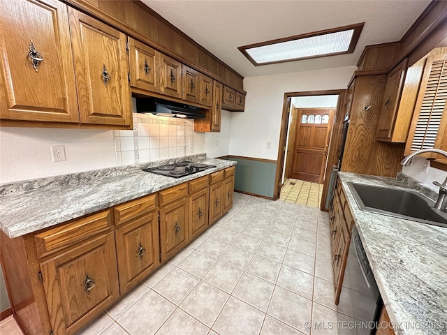 kitchen with light stone countertops, backsplash, black cooktop, sink, and dishwasher