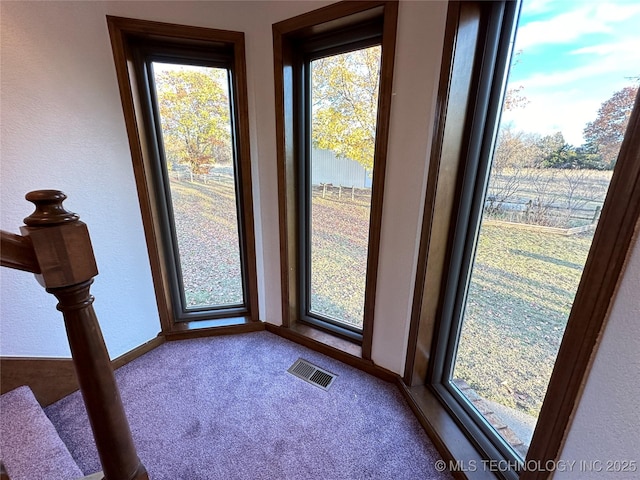 entryway with light colored carpet