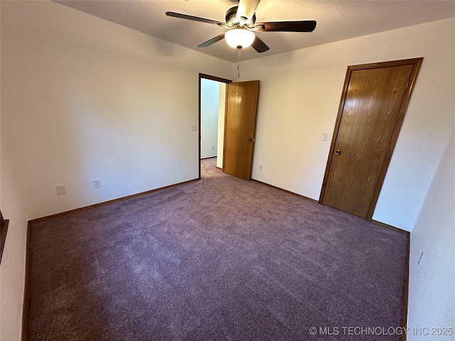 carpeted spare room with ceiling fan