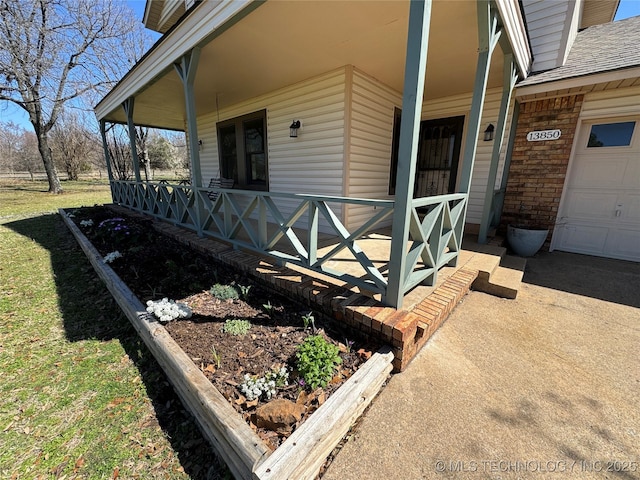 view of side of property featuring a porch and a garage