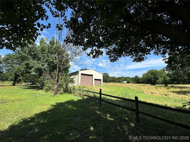 view of yard featuring a garage and an outdoor structure