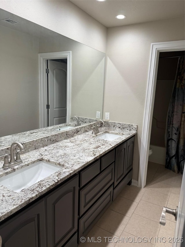 bathroom with tile patterned flooring, vanity, and toilet