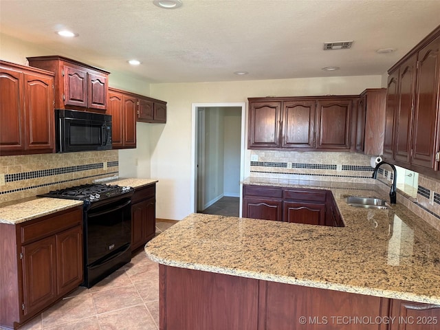 kitchen with light stone countertops, sink, backsplash, light tile patterned floors, and black appliances