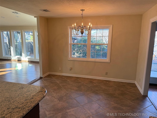 unfurnished dining area with an inviting chandelier