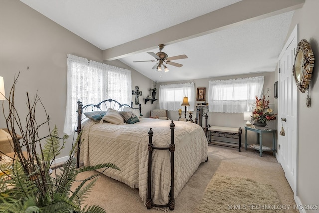 carpeted bedroom with ceiling fan, lofted ceiling with beams, and a textured ceiling