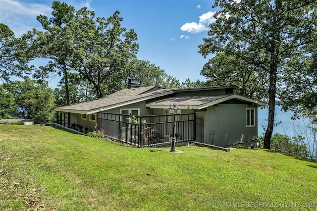 back of house with a yard