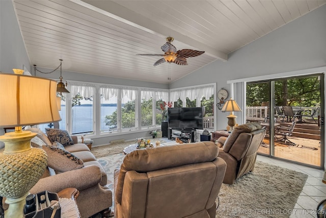 living room with tile patterned floors, ceiling fan, lofted ceiling with beams, and a healthy amount of sunlight