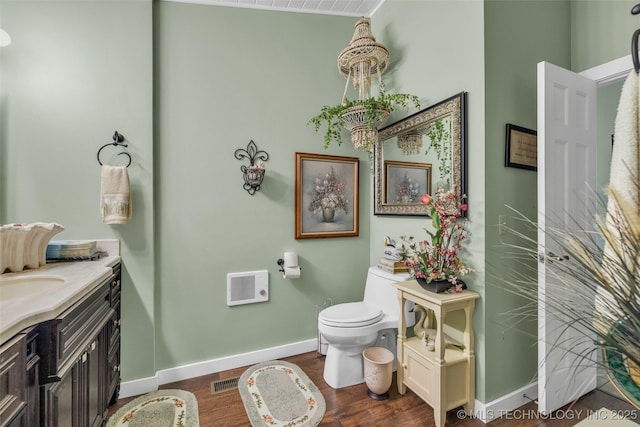 bathroom featuring hardwood / wood-style flooring, vanity, and toilet