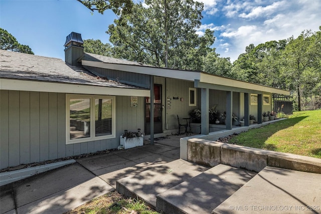 view of front facade with a patio and a front yard