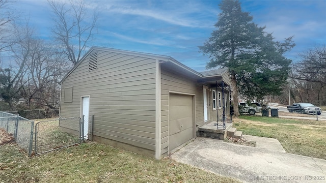 view of property exterior with a lawn and a garage