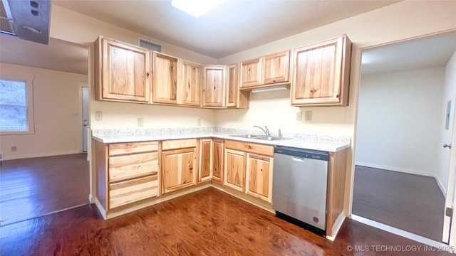 kitchen featuring dark hardwood / wood-style flooring, light brown cabinets, stainless steel dishwasher, and sink