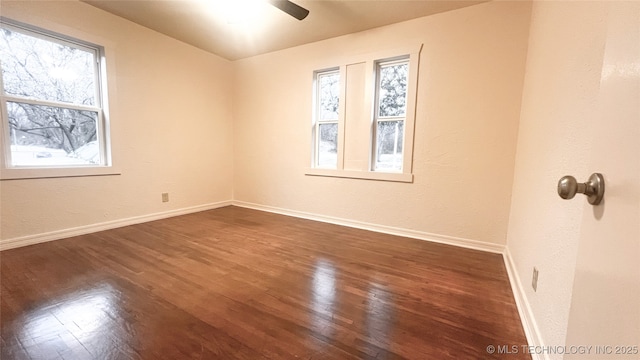 spare room featuring ceiling fan and dark hardwood / wood-style floors