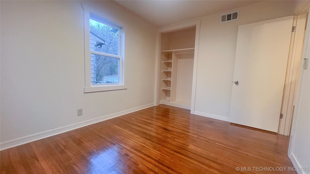 unfurnished bedroom featuring light hardwood / wood-style flooring and a closet