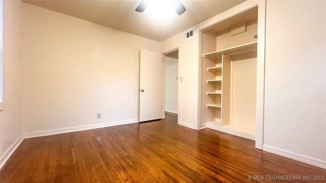 unfurnished bedroom with dark hardwood / wood-style floors and ceiling fan