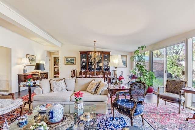 living room featuring a chandelier, hardwood / wood-style floors, and vaulted ceiling