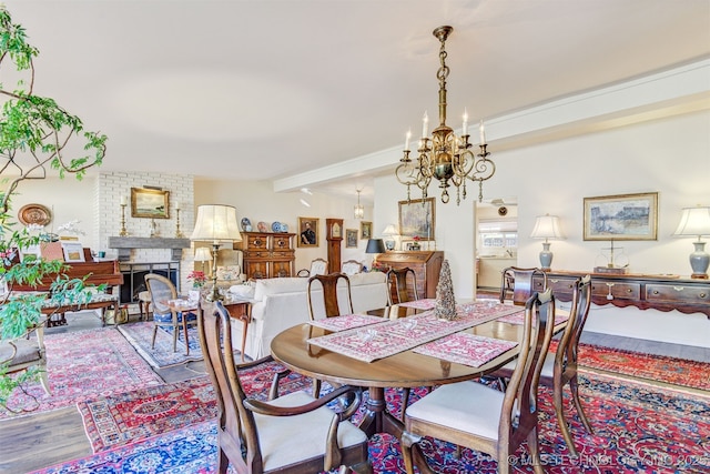 dining space with vaulted ceiling with beams, a fireplace, and hardwood / wood-style flooring