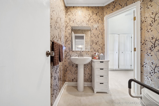 bathroom with toilet and ornamental molding