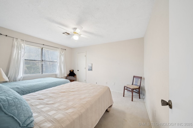 carpeted bedroom with a textured ceiling and ceiling fan