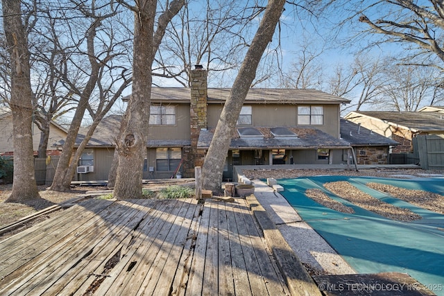 back of house with a deck and cooling unit