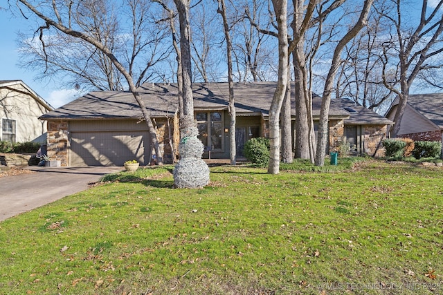 ranch-style home with a garage and a front lawn