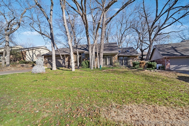 single story home with a front yard and a garage