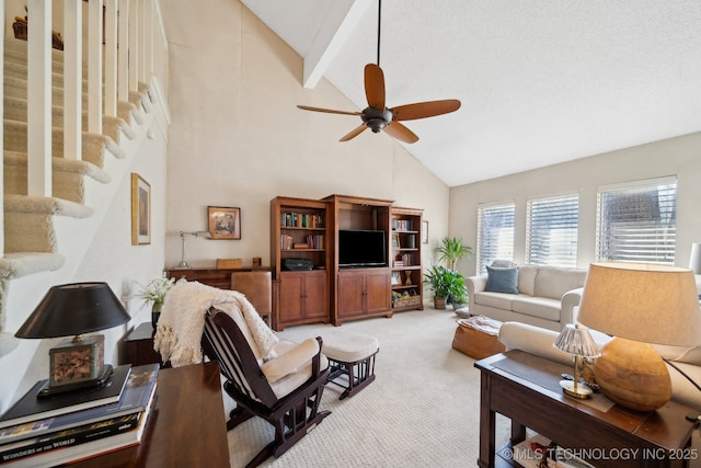 living room with ceiling fan, beam ceiling, light carpet, and high vaulted ceiling