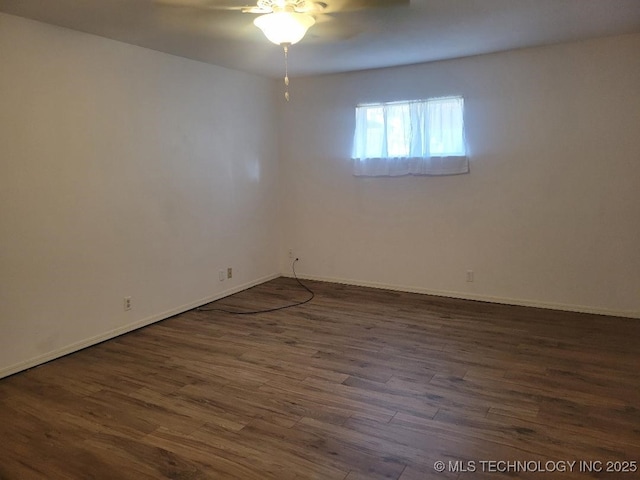 empty room featuring ceiling fan and dark wood-type flooring