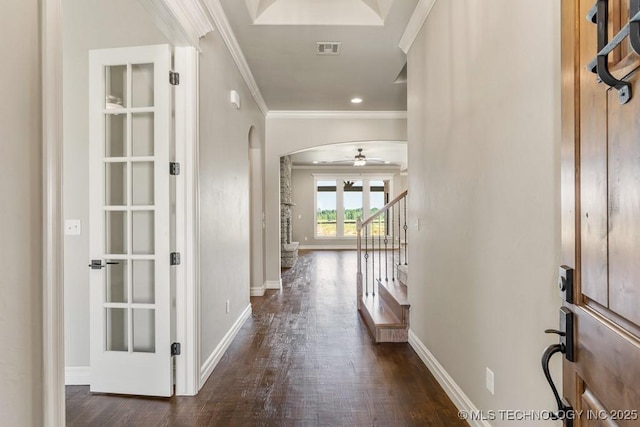 hallway with dark hardwood / wood-style flooring and ornamental molding