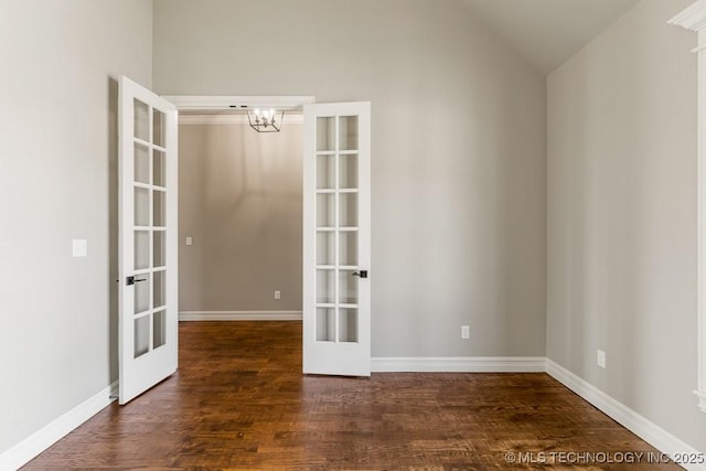 unfurnished room with dark hardwood / wood-style flooring, lofted ceiling, and french doors