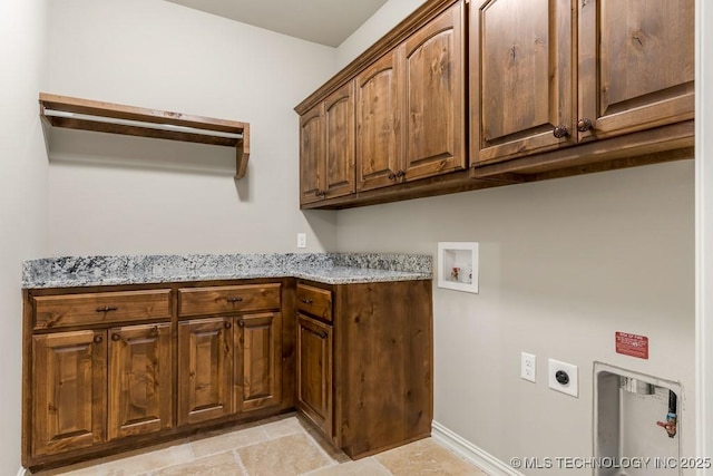 washroom with hookup for an electric dryer, cabinets, and hookup for a washing machine