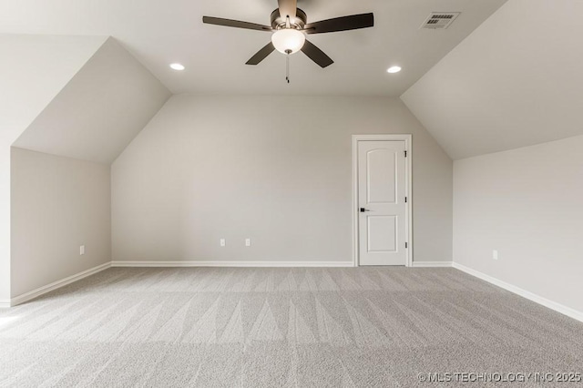 additional living space with ceiling fan, light colored carpet, and lofted ceiling